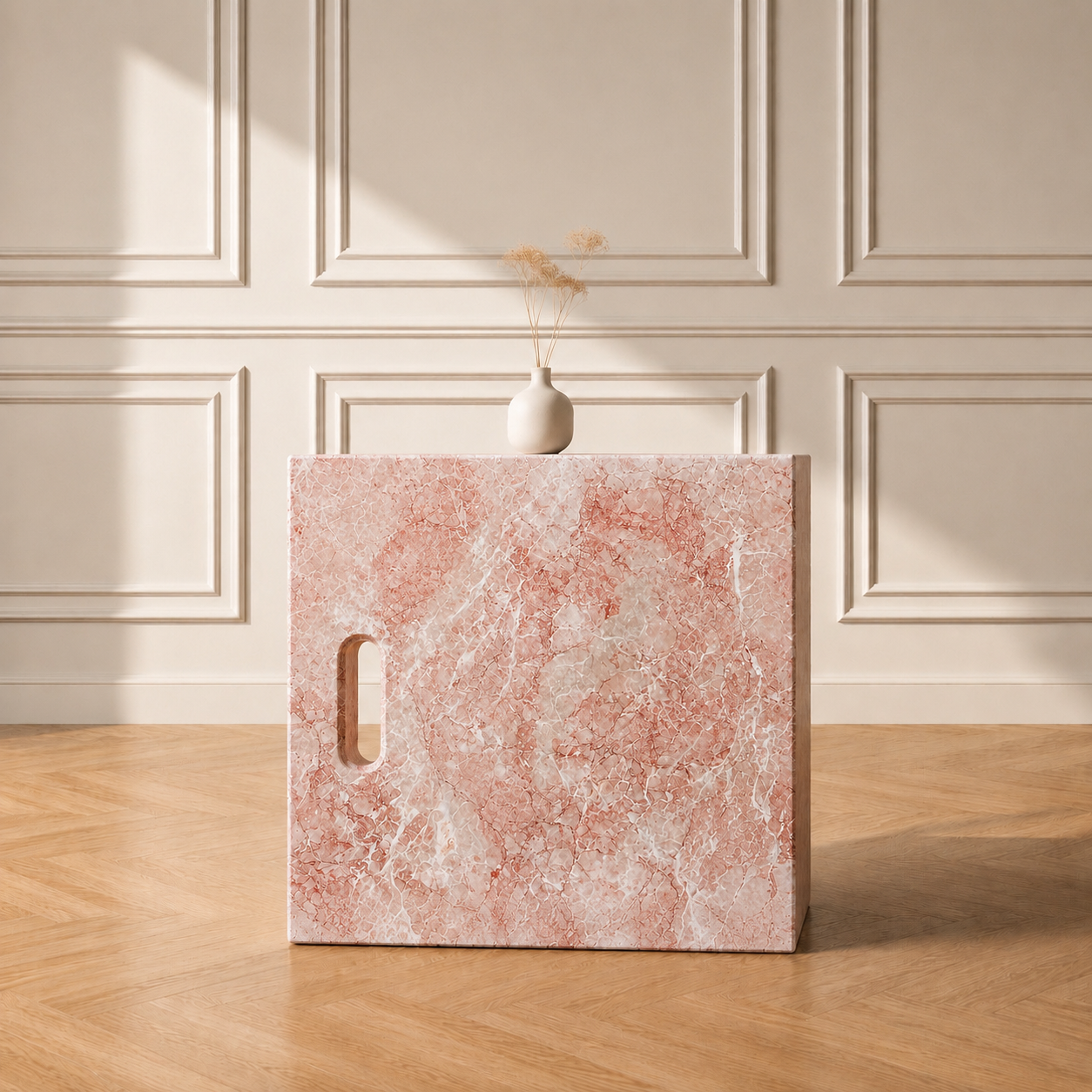 Iéna cube side table in Oriental Pink marble, styled with a vase against a panelled wall on a chevron wood floor