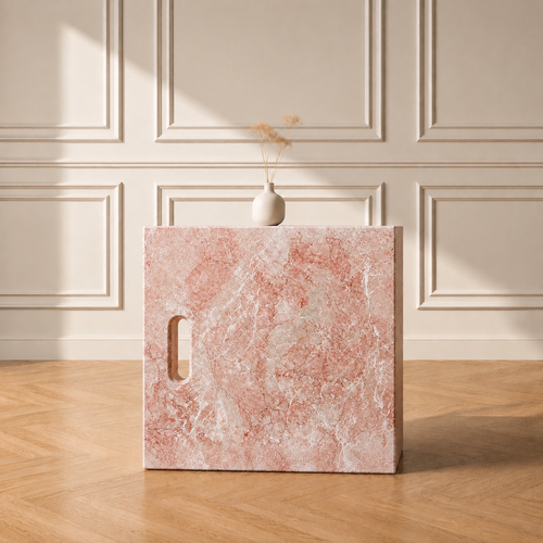 Iéna cube side table in Oriental Pink marble, styled with a vase against a panelled wall on a chevron wood floor